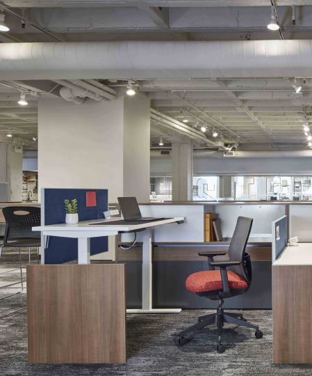 an office workspace with height-adjustable and standing-height desks