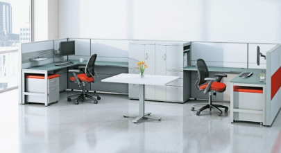 Two office workstations facing away from each other and a table in the middle.